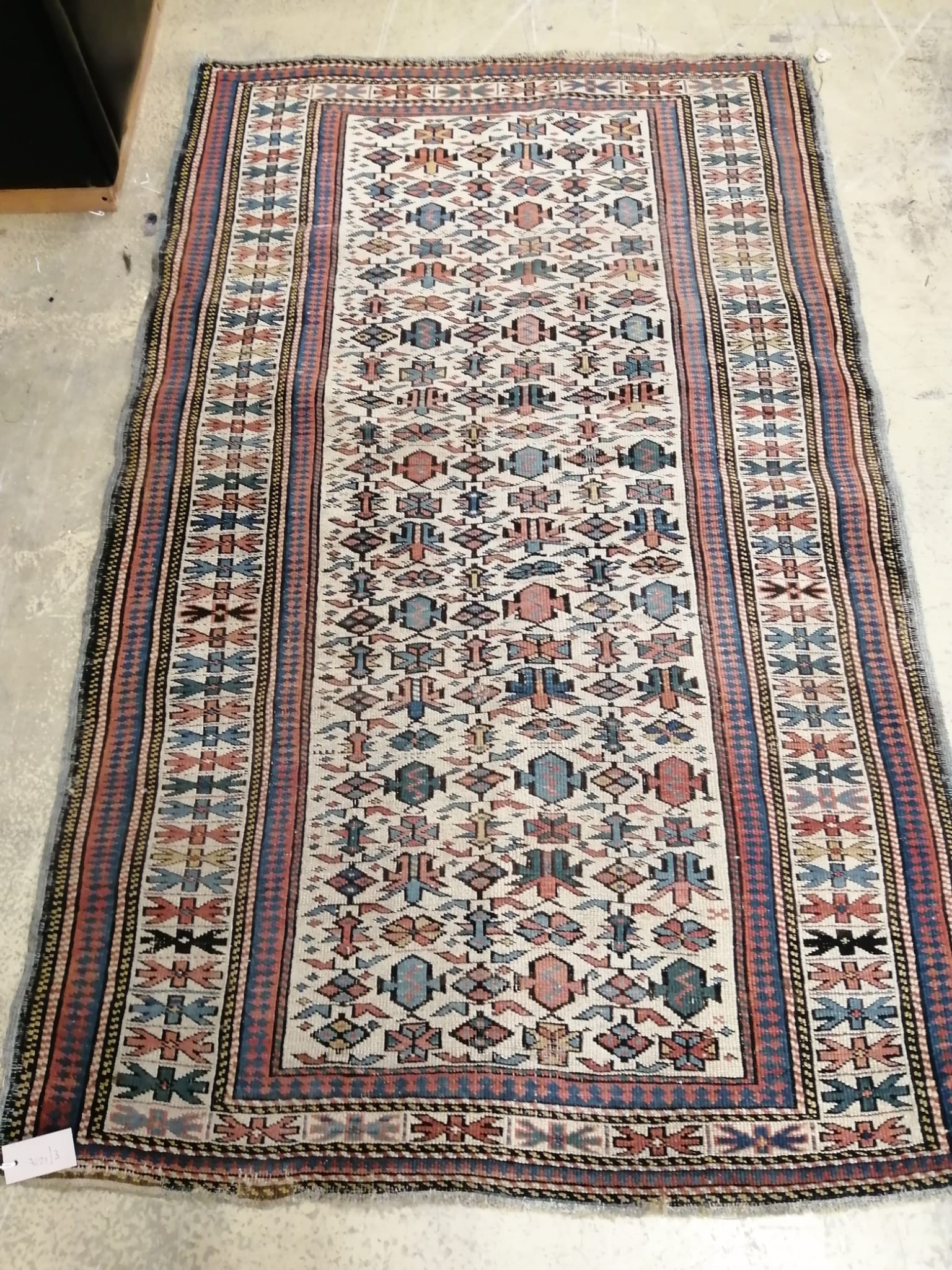 An antique Kuba ivory ground rug, 170 x 103cm